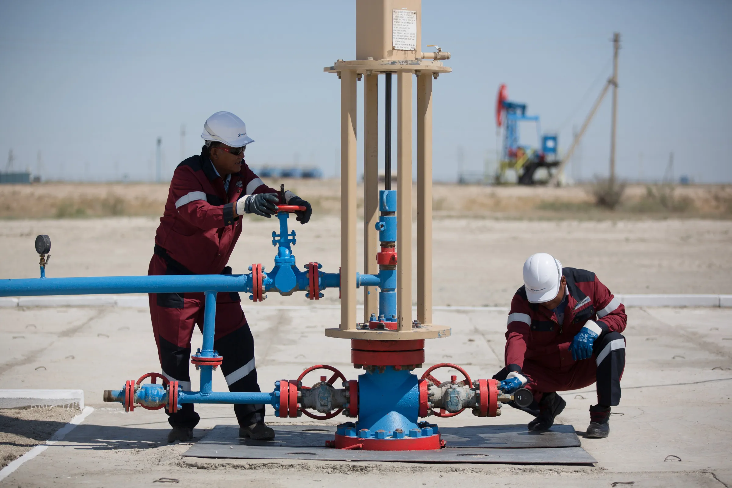 Oil field technicians at a wellhead
